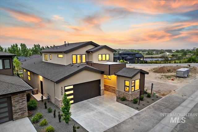 3359 E Warm Springs Ave, Boise, ID 83716 - contemporary home featuring stone siding, stucco siding, and driveway