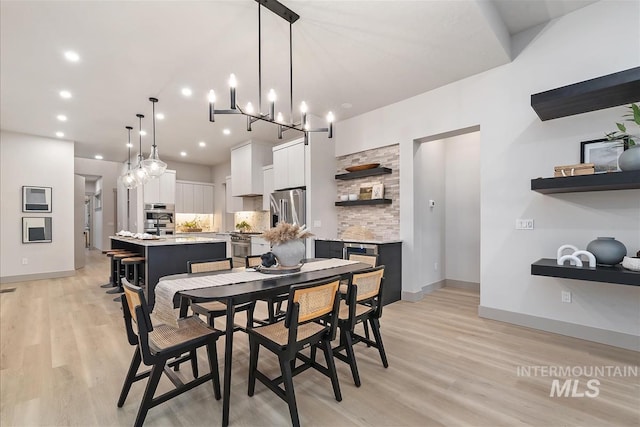 3359 E Warm Springs Ave, Boise, ID 83716 - dining area featuring light wood-style floors, recessed lighting, and a chandelier
