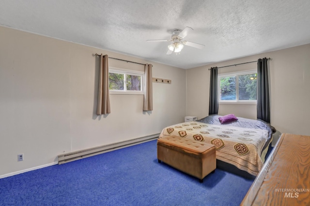 420 E 3rd St, Shoshone, ID 83352 - bedroom featuring a baseboard heating unit, multiple windows, a textured ceiling, and a ceiling fan