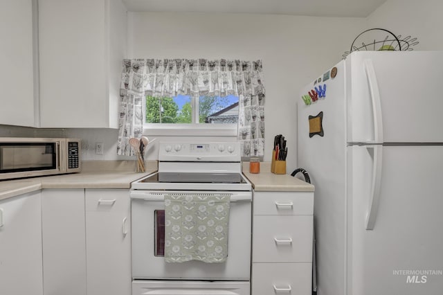 420 E 3rd St, Shoshone, ID 83352 - kitchen with white appliances, light countertops, and white cabinetry