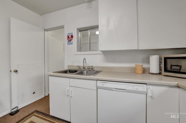 420 E 3rd St, Shoshone, ID 83352 - kitchen with white dishwasher, stainless steel microwave, a sink, and white cabinetry