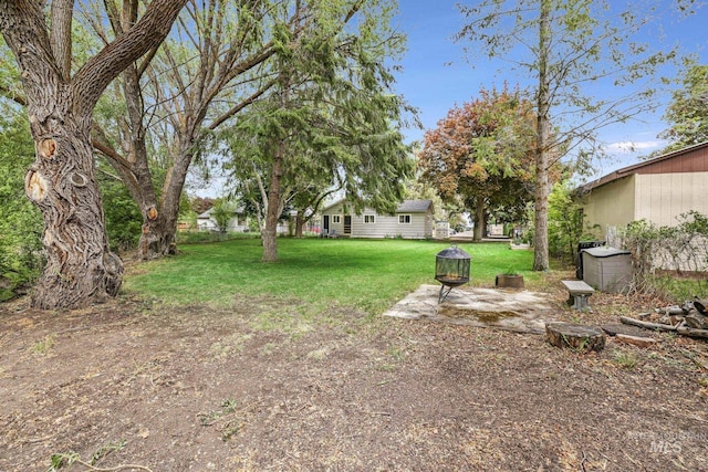 420 E 3rd St, Shoshone, ID 83352 - view of green lawn featuring a patio area