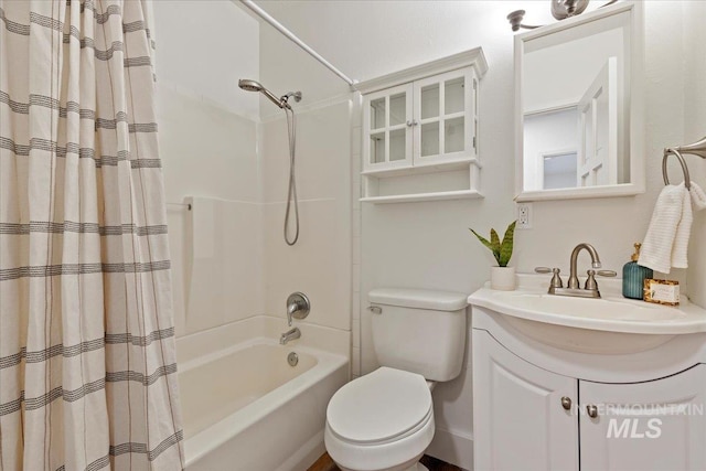 full bathroom featuring shower / tub combo with curtain, vanity, and toilet