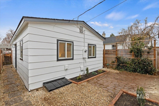 view of side of home with a patio area