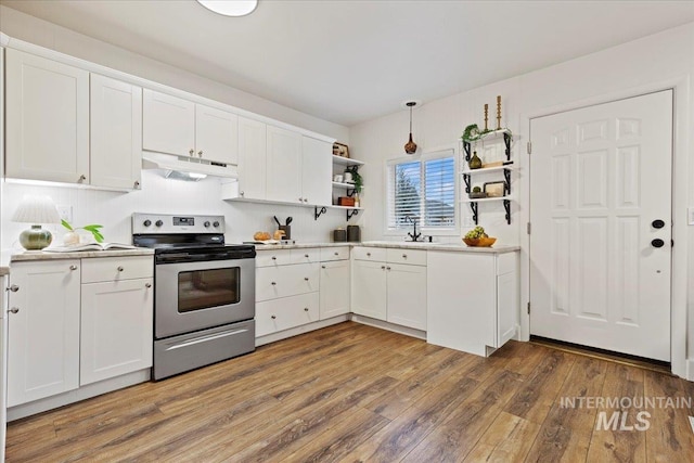 kitchen featuring white cabinetry, hardwood / wood-style floors, and electric range