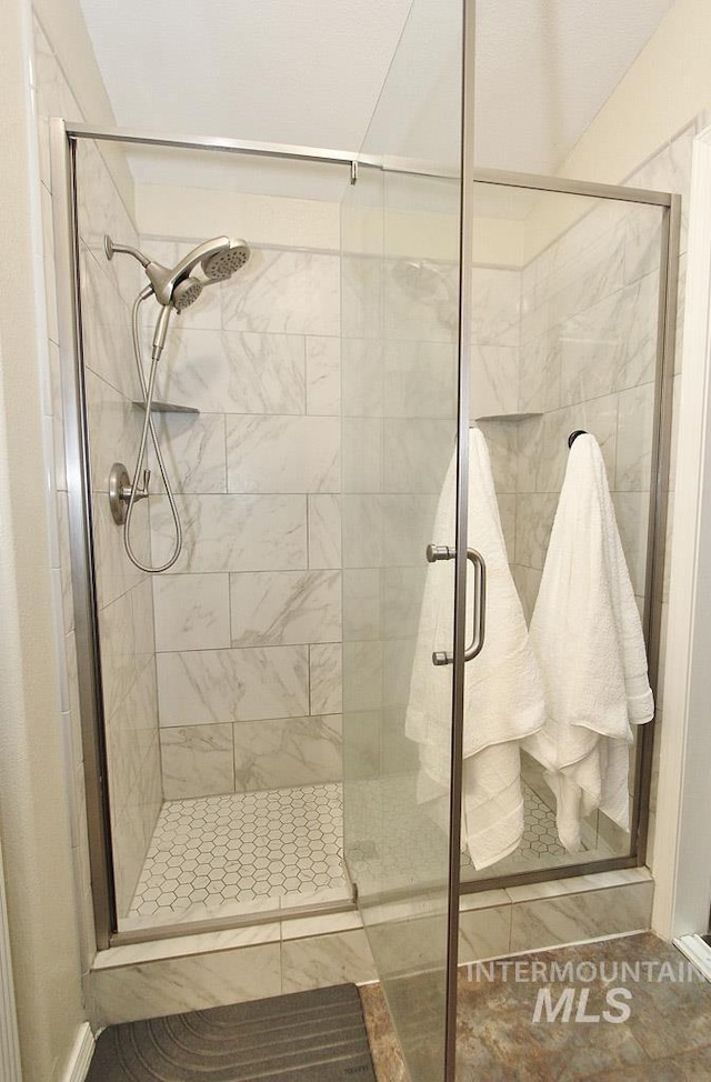 full bath featuring a shower stall