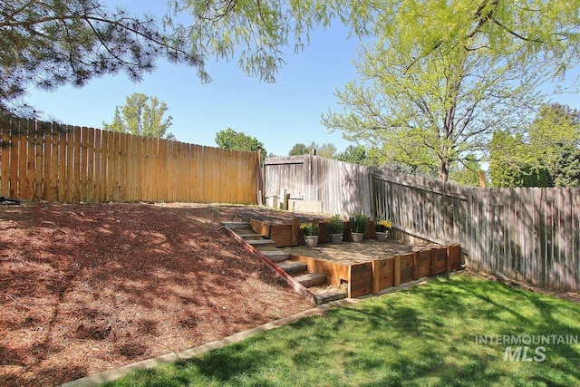 view of yard with a fenced backyard and a vegetable garden