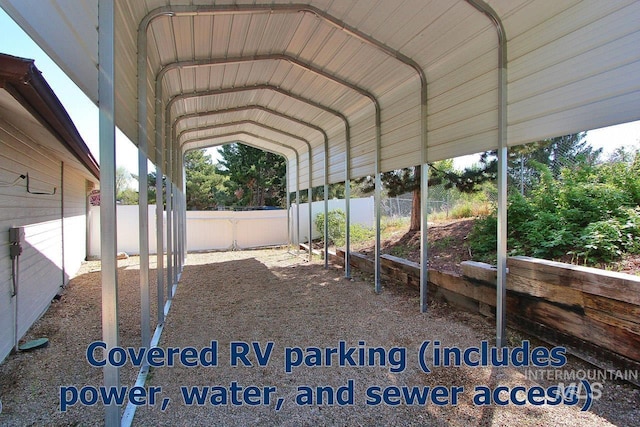 view of yard featuring fence and a carport