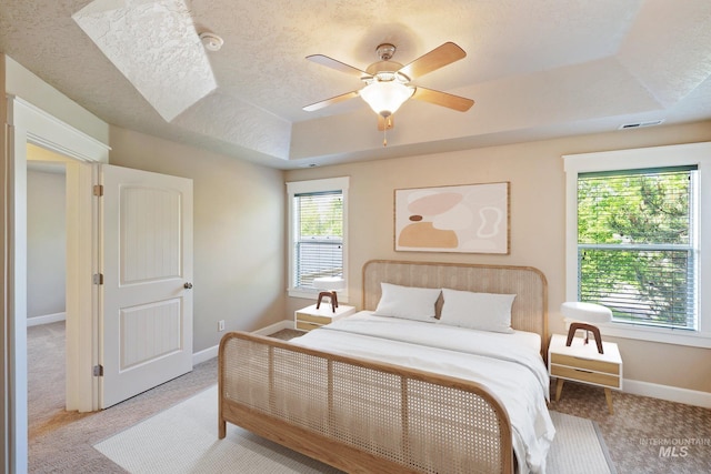 3993 N Heritage View Ave, Meridian, ID 83646 - bedroom with a raised ceiling, light carpet, baseboards, ceiling fan, and a textured ceiling