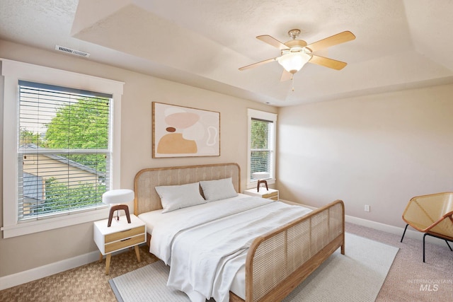 3993 N Heritage View Ave, Meridian, ID 83646 - carpeted bedroom with baseboards, a tray ceiling, and ceiling fan