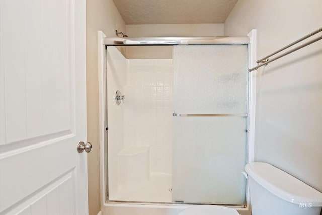 3993 N Heritage View Ave, Meridian, ID 83646 - bathroom with toilet, a shower stall, and a textured ceiling