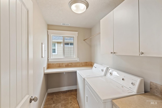 3993 N Heritage View Ave, Meridian, ID 83646 - laundry room featuring independent washer and dryer, cabinet space, baseboards, and a textured ceiling