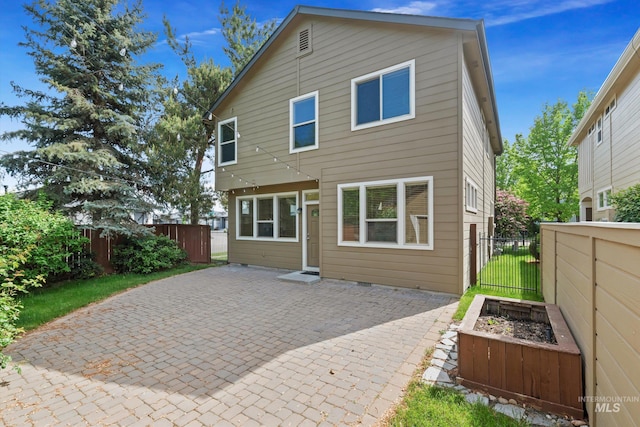 3993 N Heritage View Ave, Meridian, ID 83646 - rear view of property with a patio area and a vegetable garden