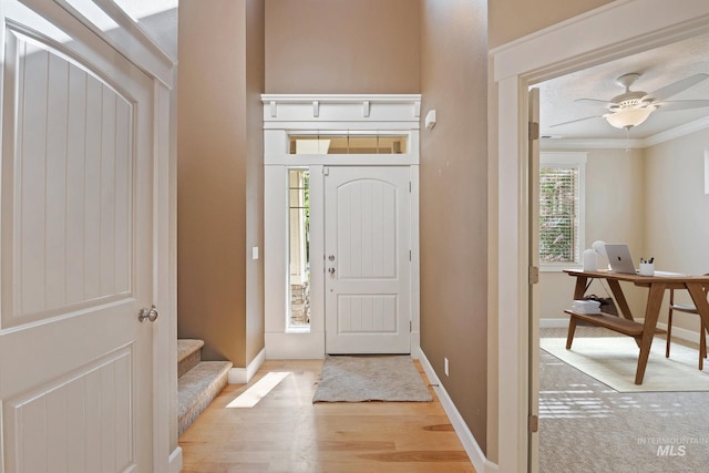 3993 N Heritage View Ave, Meridian, ID 83646 - entrance foyer featuring light wood-style flooring, baseboards, a ceiling fan, and crown molding