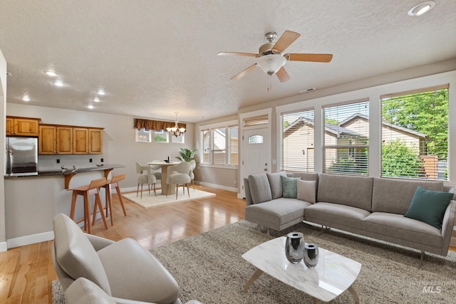 3993 N Heritage View Ave, Meridian, ID 83646 - living room with a chandelier, light wood-style flooring, baseboards, recessed lighting, and ceiling fan