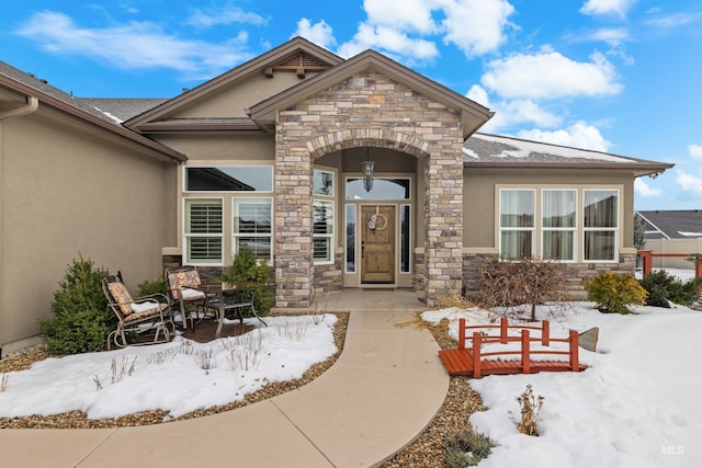 exterior space featuring stone siding and stucco siding