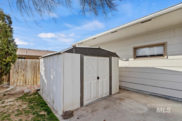 view of shed with fence