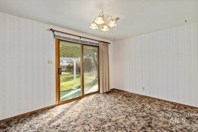 carpeted empty room with baseboards, a chandelier, and wallpapered walls