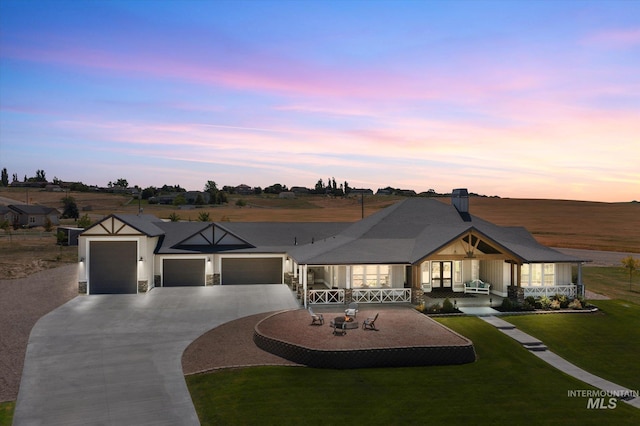 12975 Silversage Dr, Nampa, ID 83686 - view of front of house with a garage, driveway, a front lawn, covered porch, and stone siding