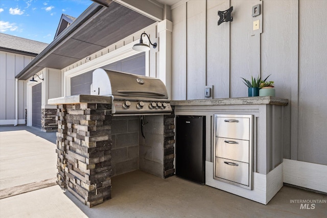 12975 Silversage Dr, Nampa, ID 83686 - view of patio featuring exterior kitchen and a garage