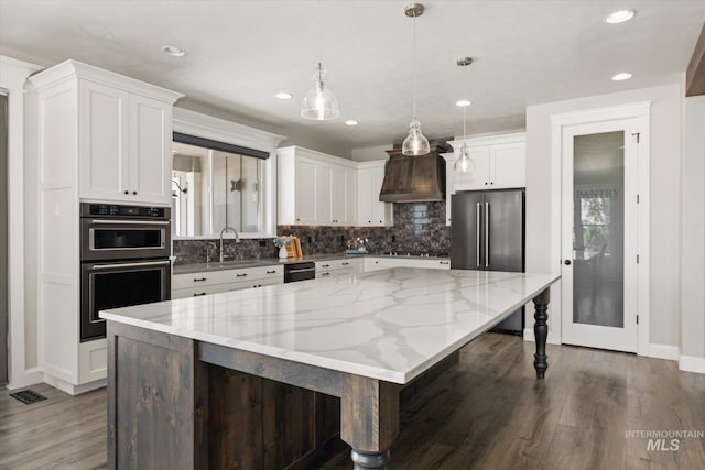 12975 Silversage Dr, Nampa, ID 83686 - kitchen featuring double oven, tasteful backsplash, dark wood-type flooring, white cabinetry, and recessed lighting