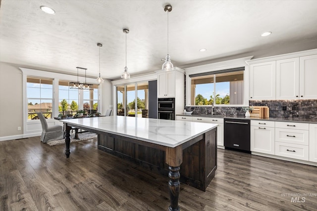 12975 Silversage Dr, Nampa, ID 83686 - kitchen featuring black appliances, decorative backsplash, dark wood-style floors, a kitchen island, and recessed lighting