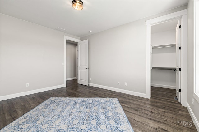 12975 Silversage Dr, Nampa, ID 83686 - unfurnished bedroom featuring wood finished floors and a walk in closet