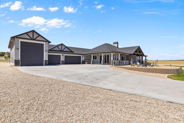 12975 Silversage Dr, Nampa, ID 83686 - view of front of house with driveway, a garage, covered porch, a chimney, and stone siding
