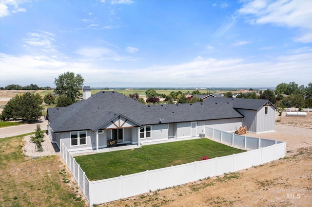 12975 Silversage Dr, Nampa, ID 83686 - view of front of property featuring a fenced backyard, roof with shingles, a patio area, and a chimney