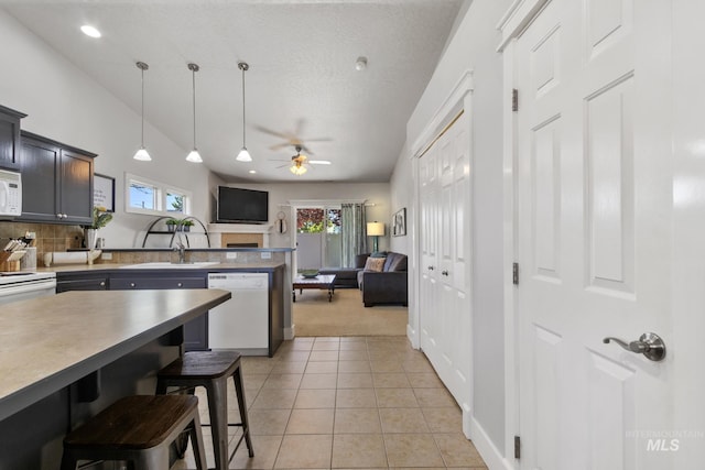 1326 N Alvey, Meridian, ID 83642 - kitchen featuring white appliances, a sink, open floor plan, a breakfast bar area, and a peninsula