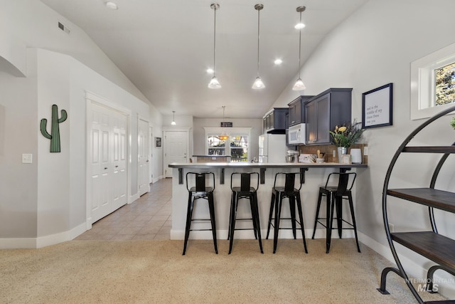1326 N Alvey, Meridian, ID 83642 - kitchen featuring white appliances, vaulted ceiling, a peninsula, a breakfast bar area, and baseboards