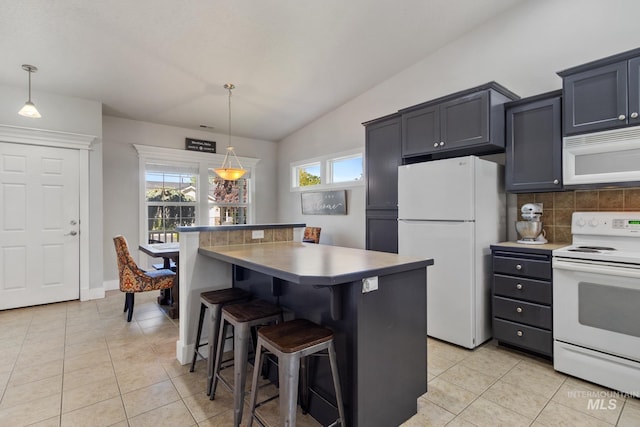 1326 N Alvey, Meridian, ID 83642 - kitchen featuring white appliances, lofted ceiling, light tile patterned flooring, a kitchen breakfast bar, and backsplash