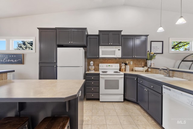 1326 N Alvey, Meridian, ID 83642 - kitchen featuring white appliances, lofted ceiling, a sink, backsplash, and light countertops