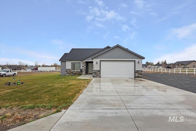 view of front of home with a front yard and a garage