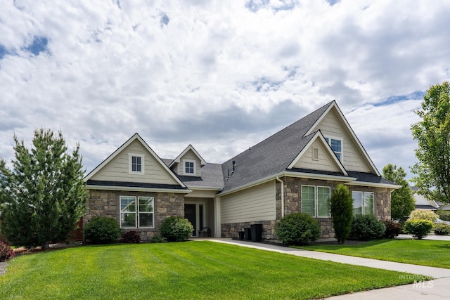 2522 N Foudy Ave, Eagle, ID 83616 - view of front of home featuring stone siding, a front yard, and roof with shingles
