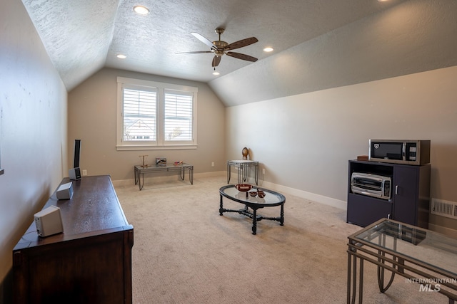 2522 N Foudy Ave, Eagle, ID 83616 - sitting room featuring lofted ceiling, a ceiling fan, a textured ceiling, light colored carpet, and baseboards