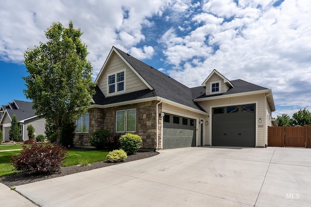2522 N Foudy Ave, Eagle, ID 83616 - view of front of property with an attached garage, concrete driveway, stone siding, and a shingled roof