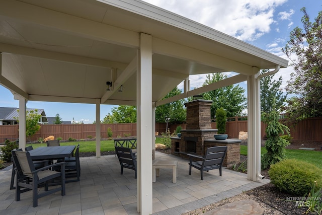 2522 N Foudy Ave, Eagle, ID 83616 - fenced backyard featuring an outdoor stone fireplace, a patio area, and outdoor dining space