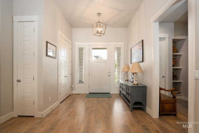 2522 N Foudy Ave, Eagle, ID 83616 - entryway with wood finished floors, baseboards, and a chandelier