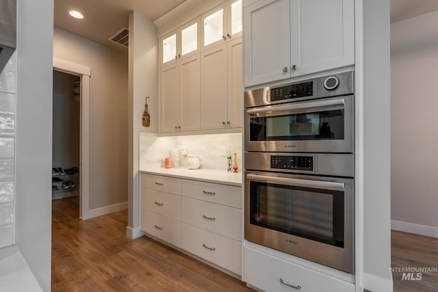 2522 N Foudy Ave, Eagle, ID 83616 - kitchen with stainless steel double oven, baseboards, light wood-style floors, tasteful backsplash, and recessed lighting