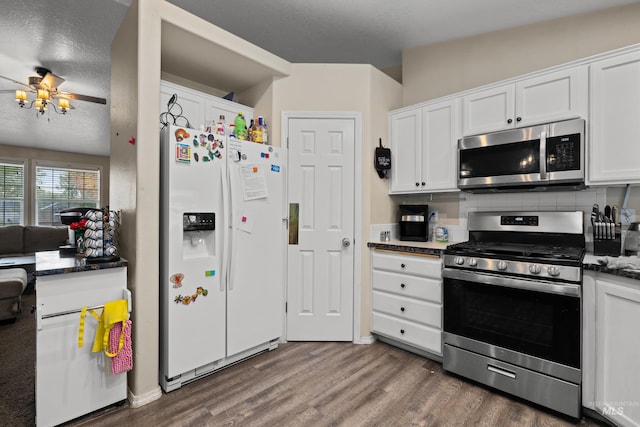 kitchen featuring ceiling fan, appliances with stainless steel finishes, dark hardwood / wood-style flooring, white cabinetry, and a textured ceiling