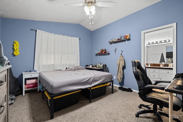 bedroom with connected bathroom, vaulted ceiling, carpet flooring, a textured ceiling, and ceiling fan