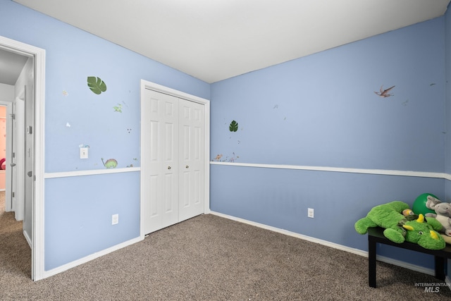 unfurnished bedroom featuring a closet and carpet floors