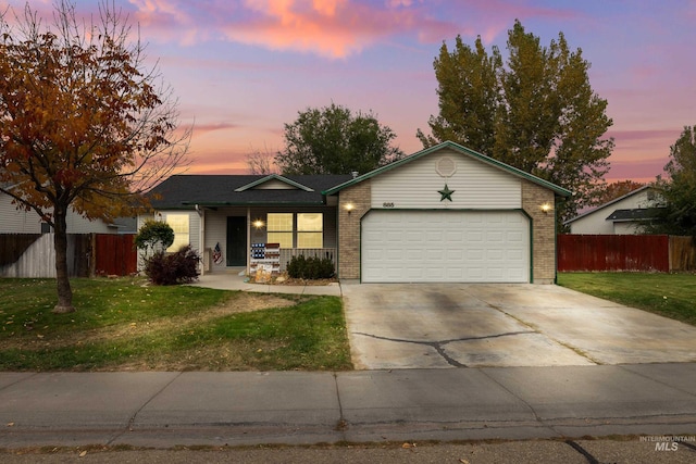 ranch-style house featuring a yard, covered porch, and a garage