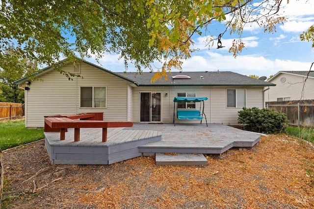 rear view of property with a wooden deck