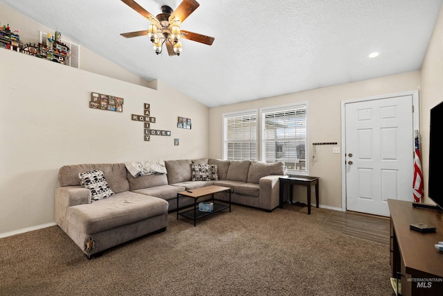 carpeted living room featuring vaulted ceiling, a textured ceiling, and ceiling fan