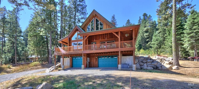 log-style house featuring a garage and a deck