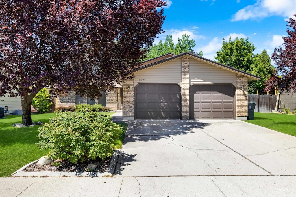 3877 S W Point Pl, Boise, ID 83706 - view of front of home featuring brick siding, an attached garage, concrete driveway, and cooling unit