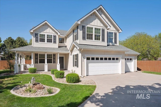view of front of property with fence, board and batten siding, concrete driveway, an attached garage, and a porch