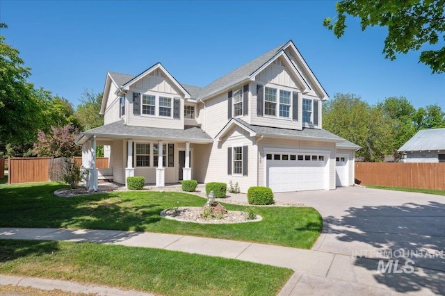traditional home featuring concrete driveway, fence, board and batten siding, and a garage